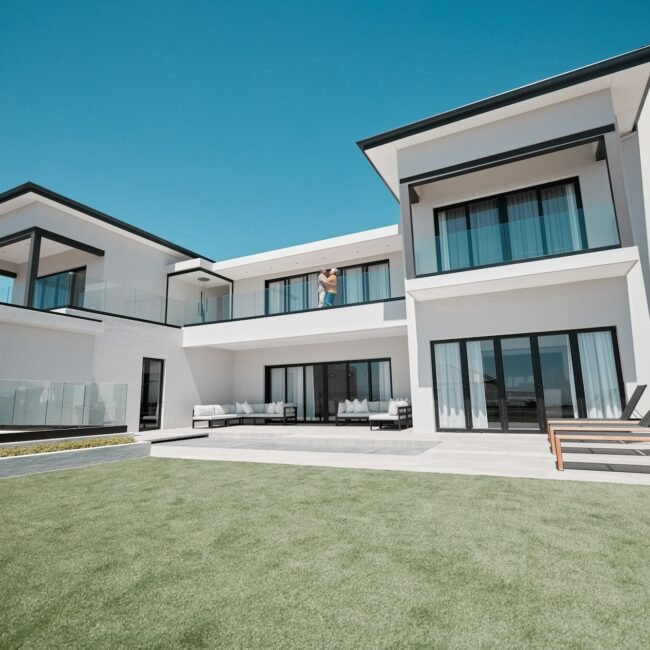 House, property and elderly couple on a balcony, relax and bonding at their dream home. Real estate